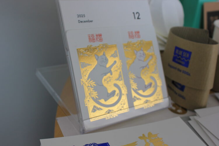 金箔と型押し(エンボス加工)で猫の絵が立体的に表現された卓上カレンダーの印刷サンプル。
